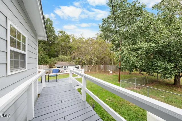 a view of a patio with chairs next to a yard