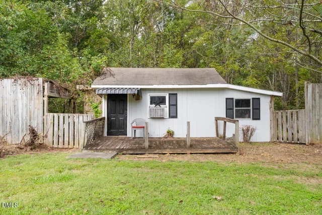 a front view of house with yard outdoor seating and barbeque oven