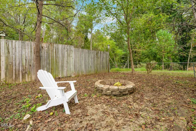 a view of a house with backyard and a patio