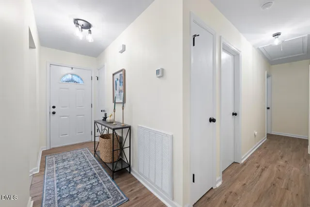 a view of hallway with wooden floor