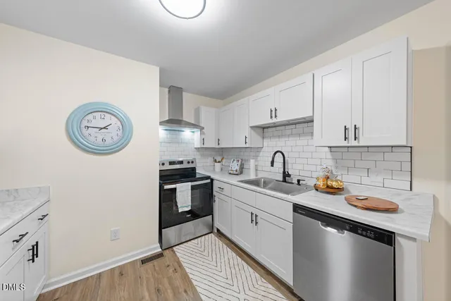 a kitchen with stainless steel appliances granite countertop a sink and a stove top oven