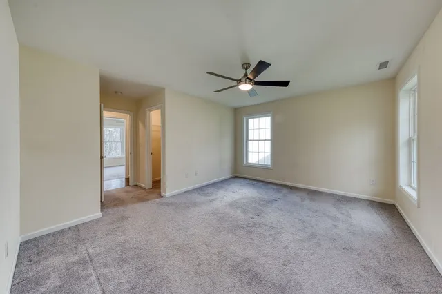a view of a livingroom with a ceiling fan and window