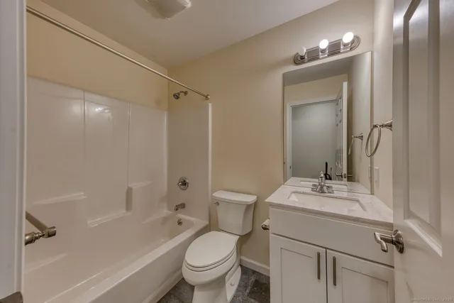 a bathroom with a sink toilet tub and shower
