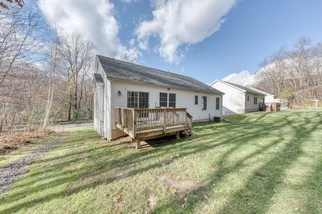 a white house sitting in the middle of a yard