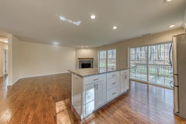 a large kitchen with kitchen island a sink stainless steel appliances and cabinets
