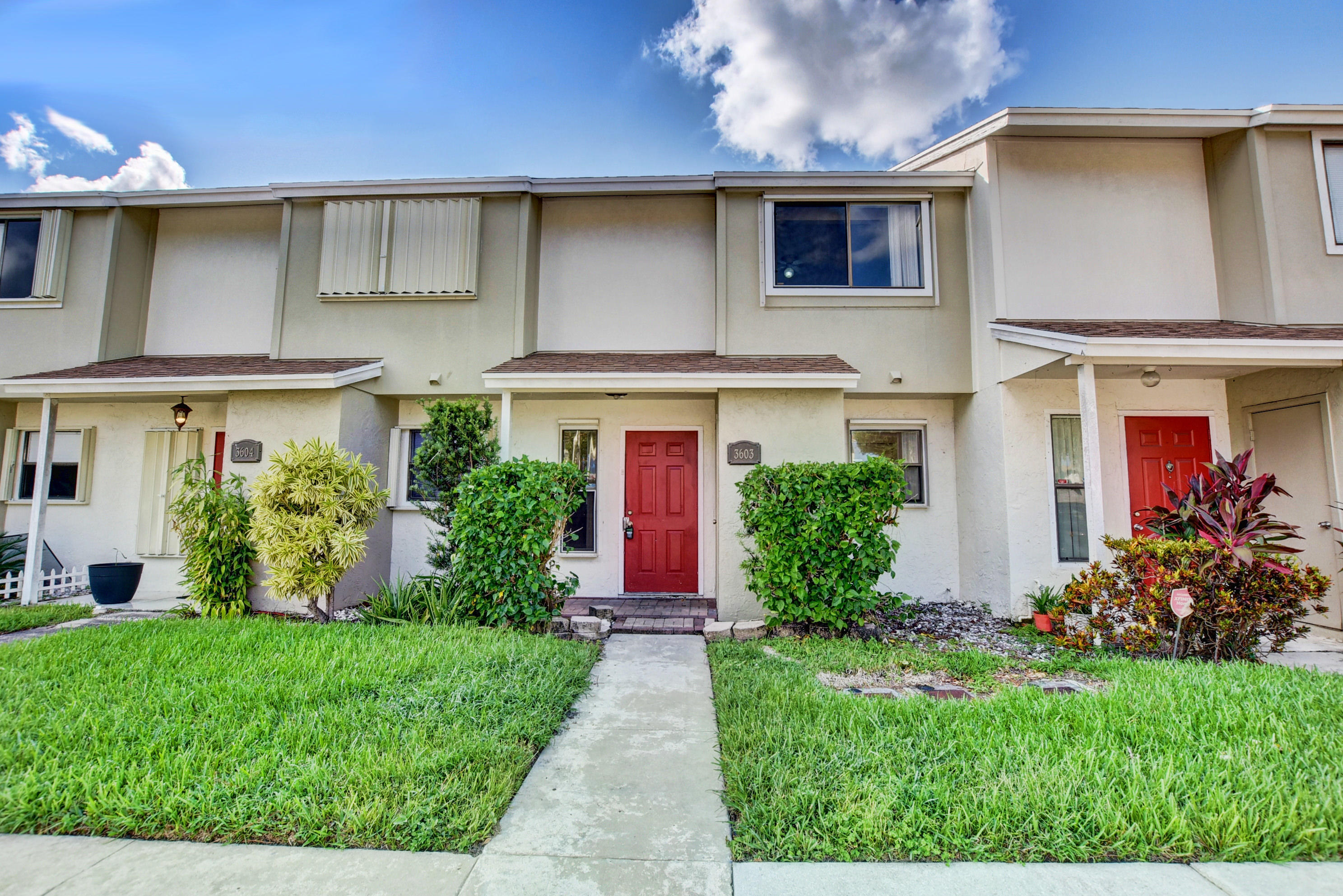 a front view of house with yard and outdoor seating