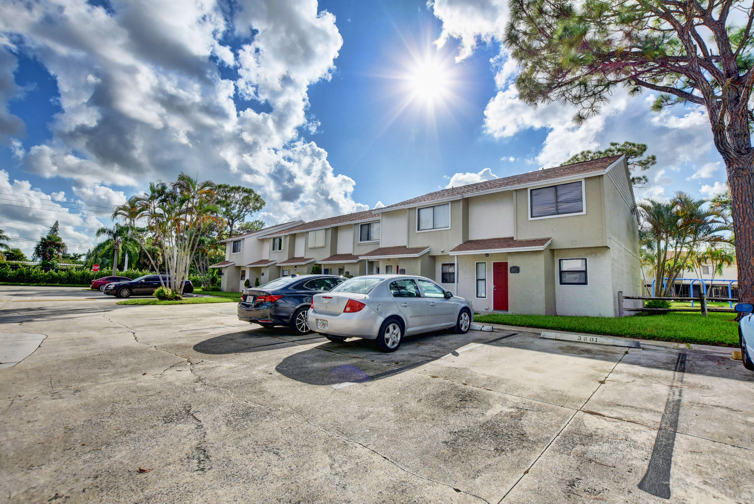 3603 Inlet Circle Greenacres, FL 33463 - Photo 2 of 34 a view of street with parked cars