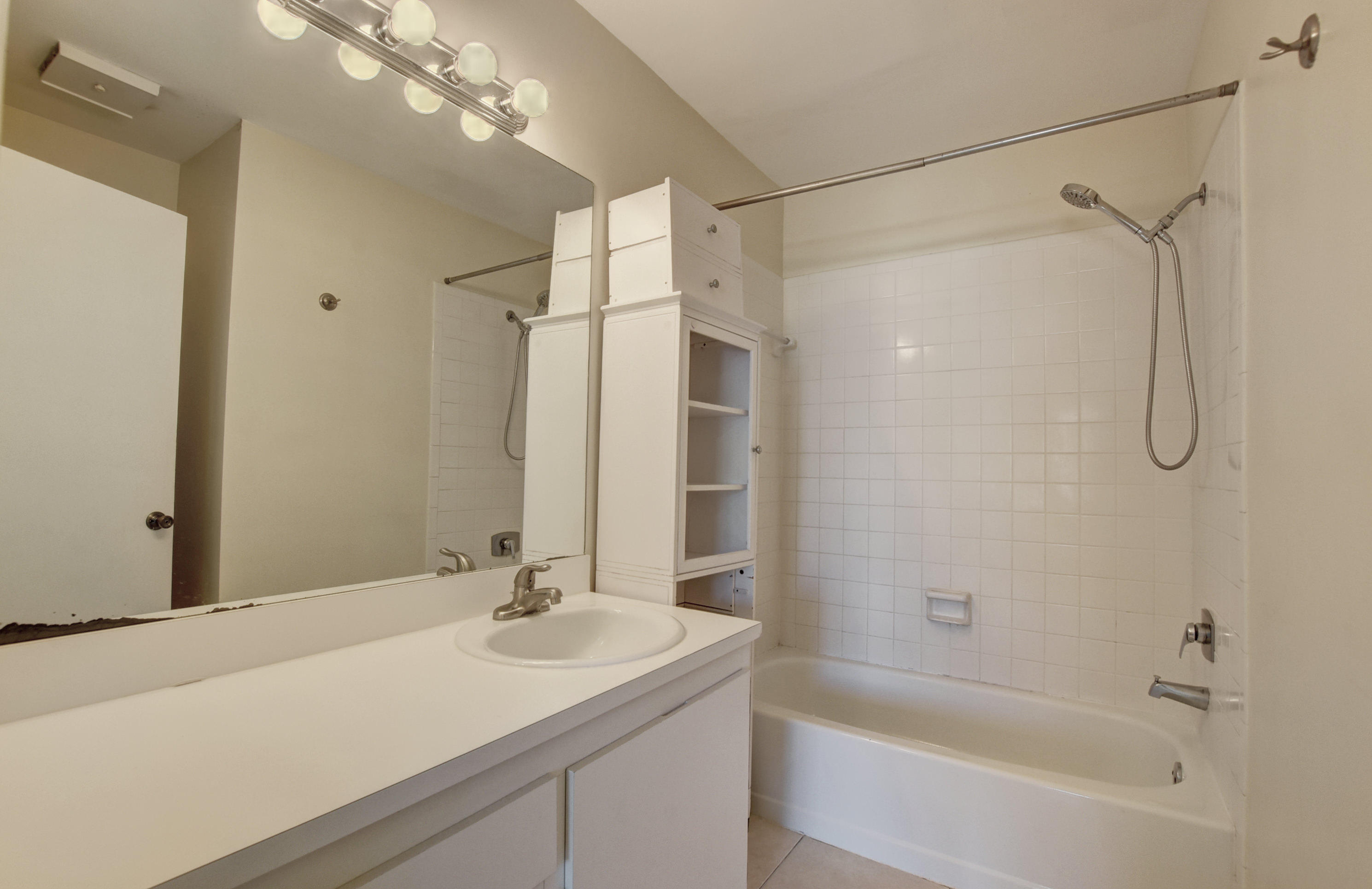3603 Inlet Circle Greenacres, FL 33463 - Photo 25 of 34 a bathroom with a sink double vanity granite tub shower and a mirror