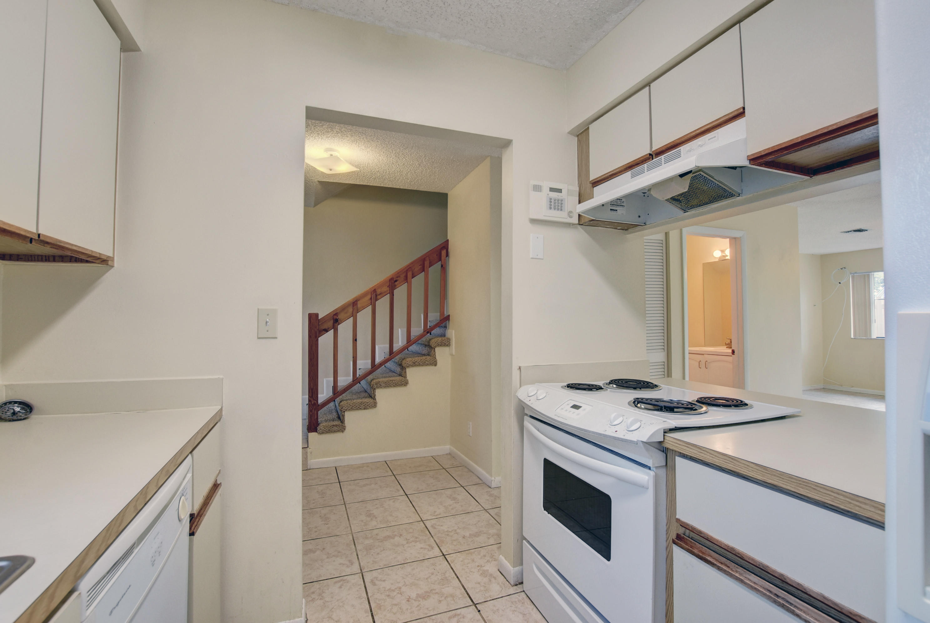 3603 Inlet Circle Greenacres, FL 33463 - Photo 9 of 34 a kitchen with granite countertop a sink a stove and cabinets