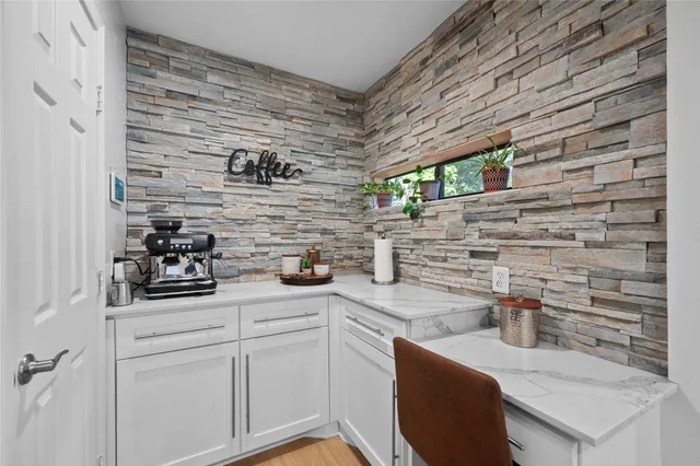 a bedroom with a bed couch and a chandelier