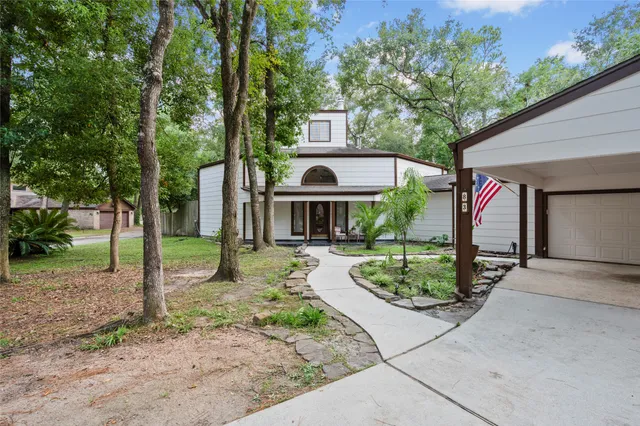 a kitchen with stainless steel appliances kitchen island granite countertop a table chairs and white cabinets