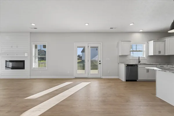 a large kitchen with granite countertop a stove a sink and a granite counter tops