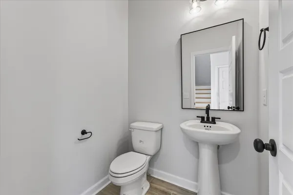 a bathroom with a sink mirror toilet and a mirror