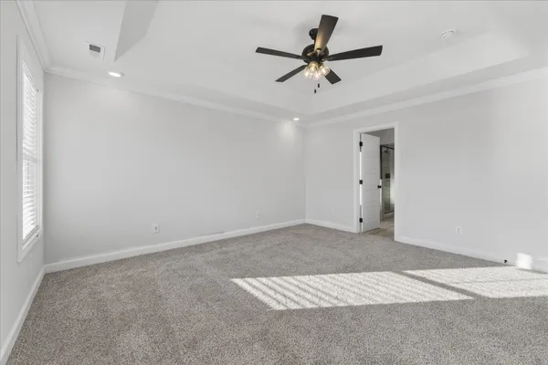a view of a livingroom with a ceiling fan and window