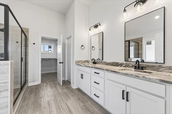 a bathroom with a double vanity sink and mirror