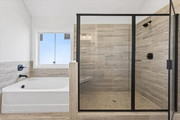 a bathroom with a bathtub and shower