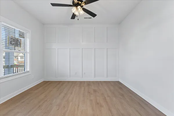 wooden floor in an empty room with a window