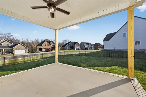 a view of green field with house in background
