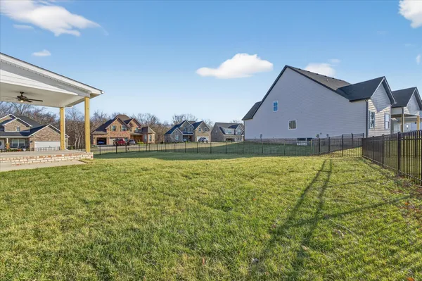 a view of a house with a backyard