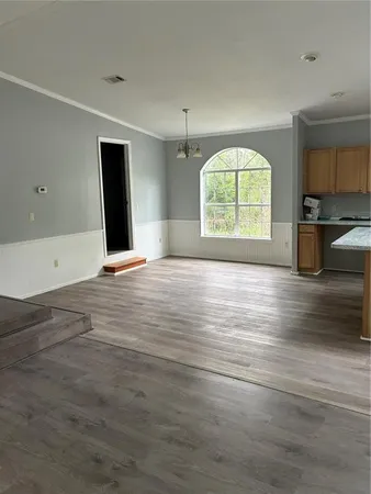 an empty room with windows and a fireplace
