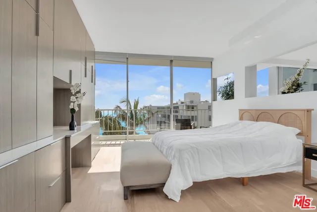 a bedroom with a large bed and a large window