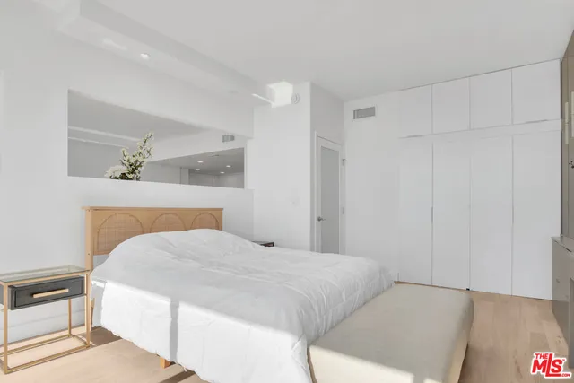 a bedroom with a bed and a cabinets