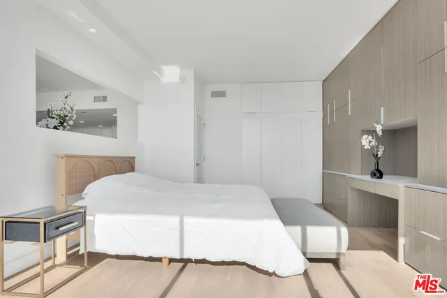 a bedroom with a bed and a table in it