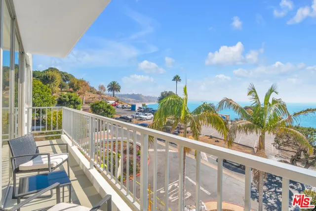 a view of a balcony with wooden floor and outdoor space