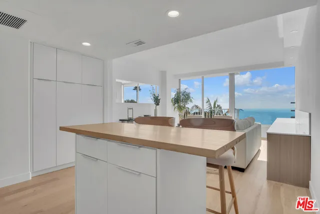 a kitchen with stainless steel appliances granite countertop a sink and a refrigerator