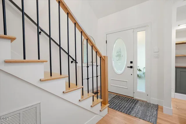 a view of staircase with wooden floor and a potted plant