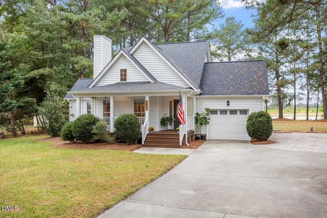 a view of a house with a patio and a yard