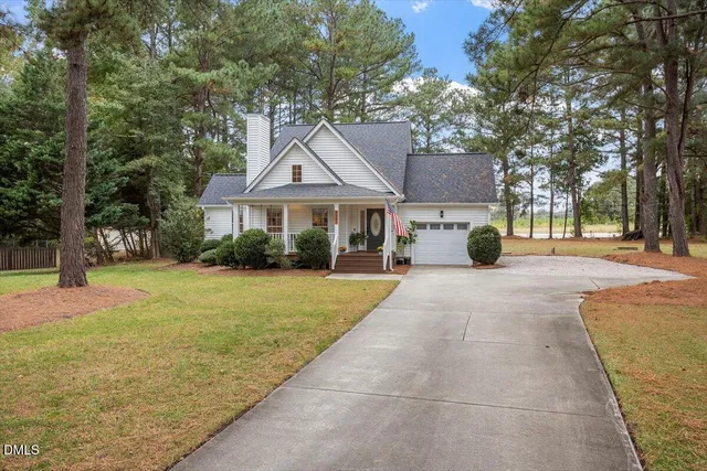 a view of a house with a yard and tree s