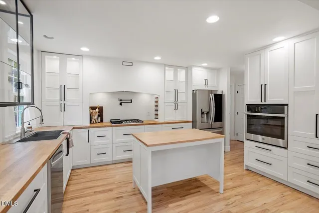 a kitchen with stainless steel appliances a stove sink and refrigerator