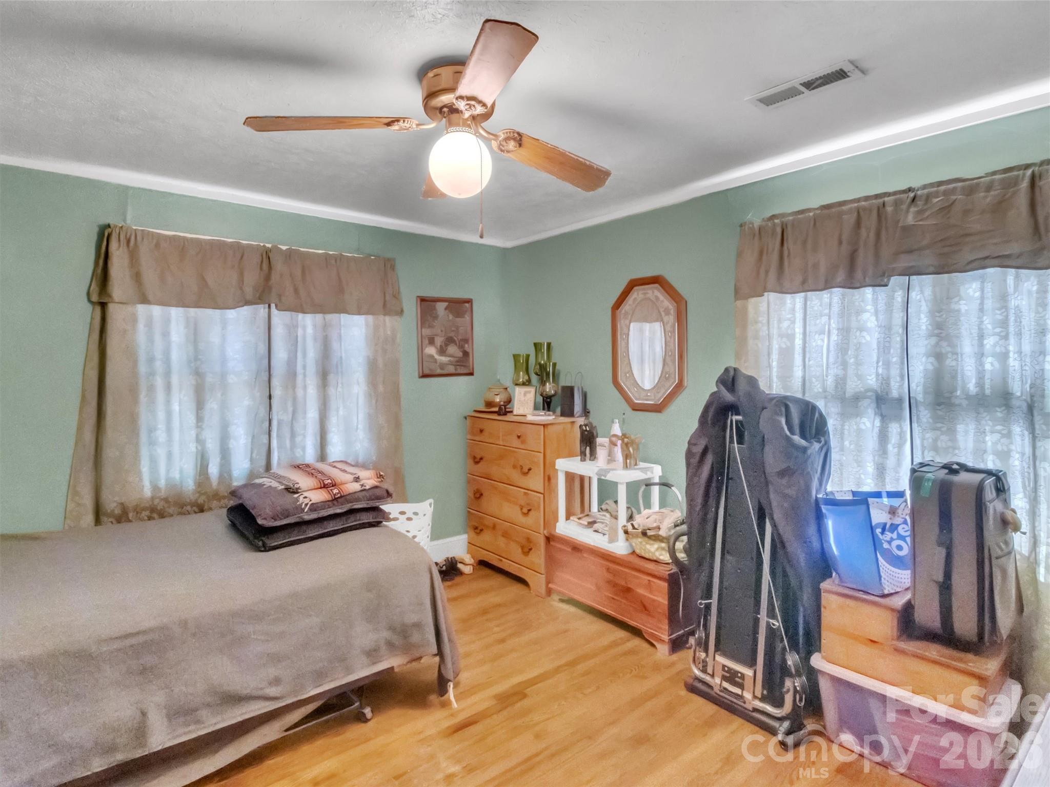 301 Mulberry Street Clyde, NC 28721 - Photo 11 of 23 a bedroom with bed and a chandelier