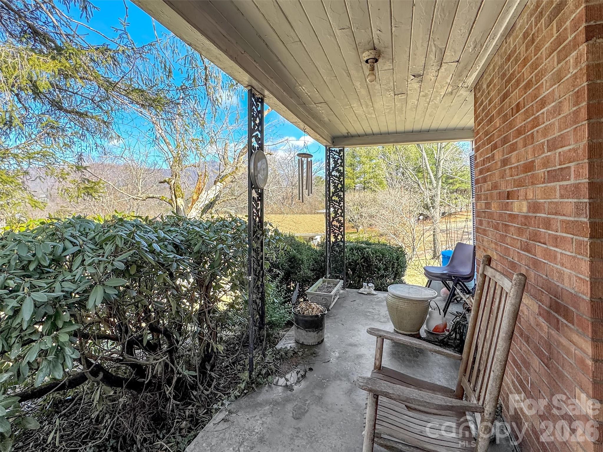 301 Mulberry Street Clyde, NC 28721 - Photo 12 of 23 a view of a patio with table and chairs and potted plants