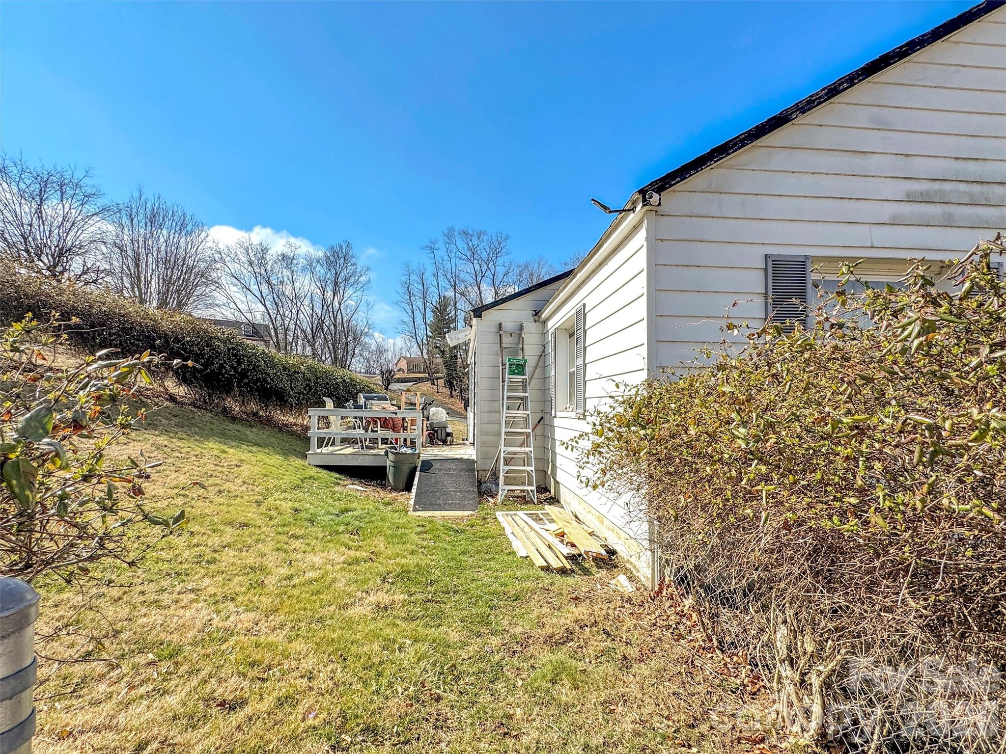 301 Mulberry Street Clyde, NC 28721 - Photo 17 of 23 a view of a chair and table in backyard