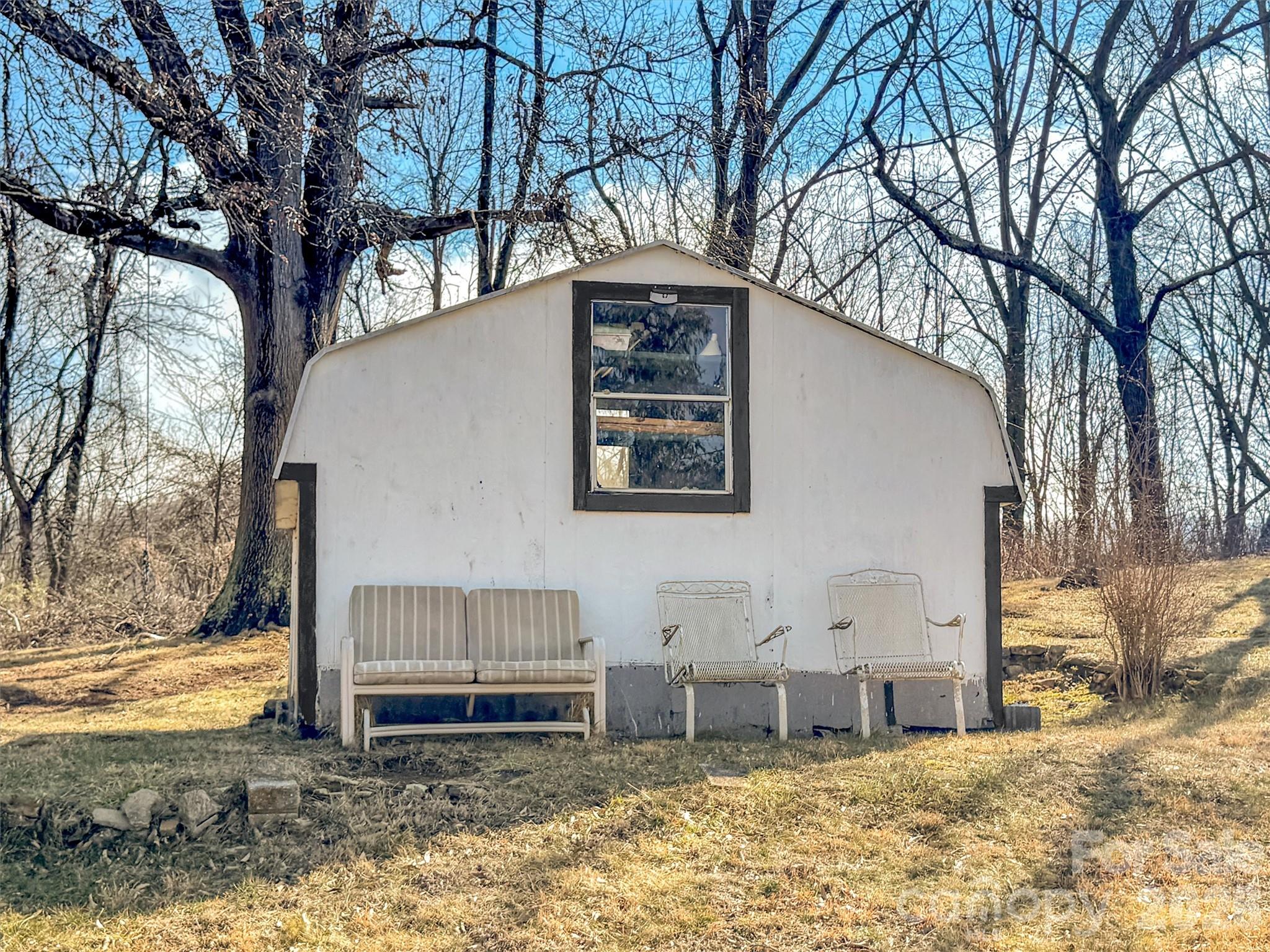 301 Mulberry Street Clyde, NC 28721 - Photo 19 of 23 a backyard of a house with barbeque oven and outdoor seating