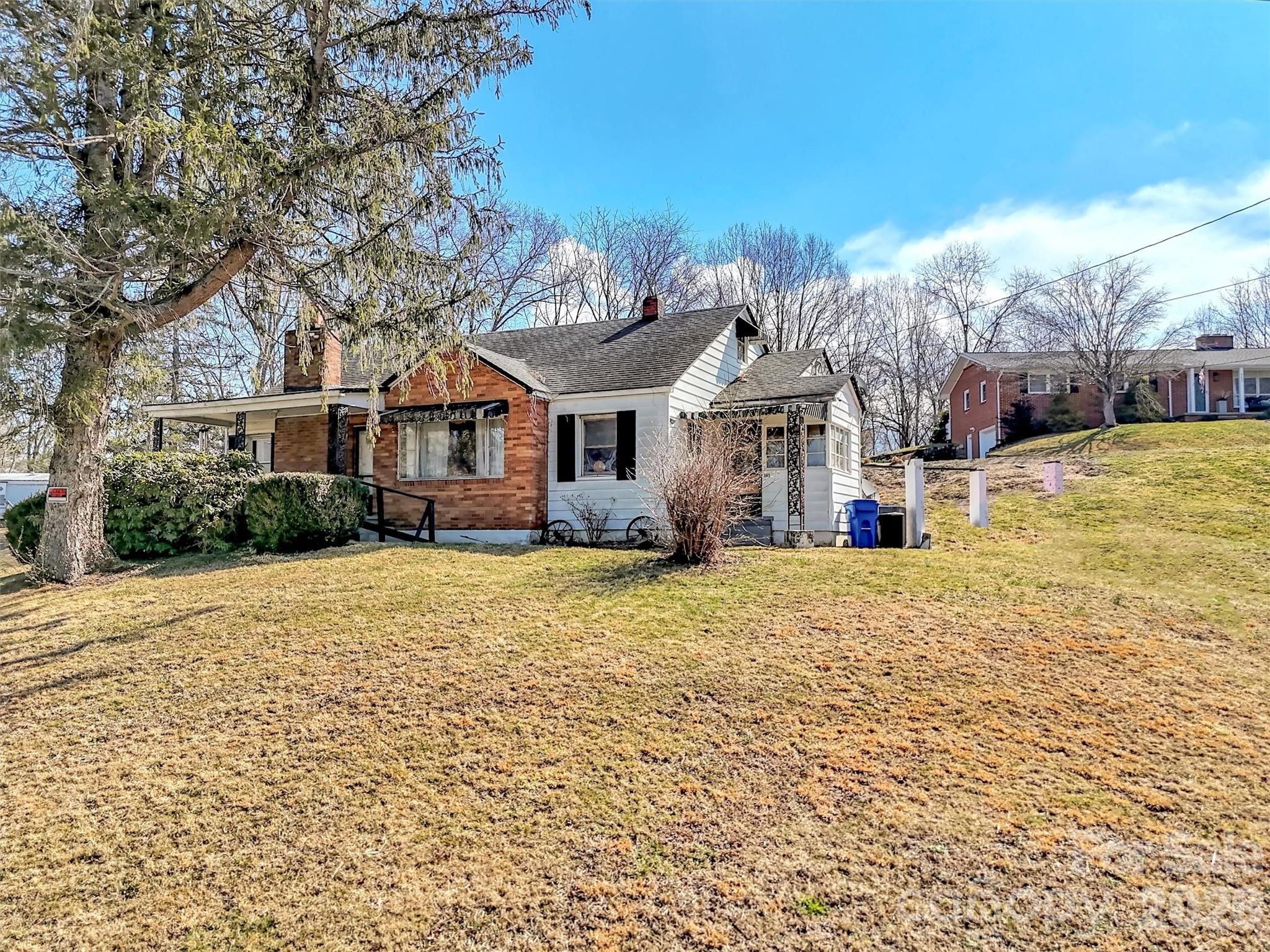 301 Mulberry Street Clyde, NC 28721 - Photo 22 of 23 a front view of a house with a yard and trees