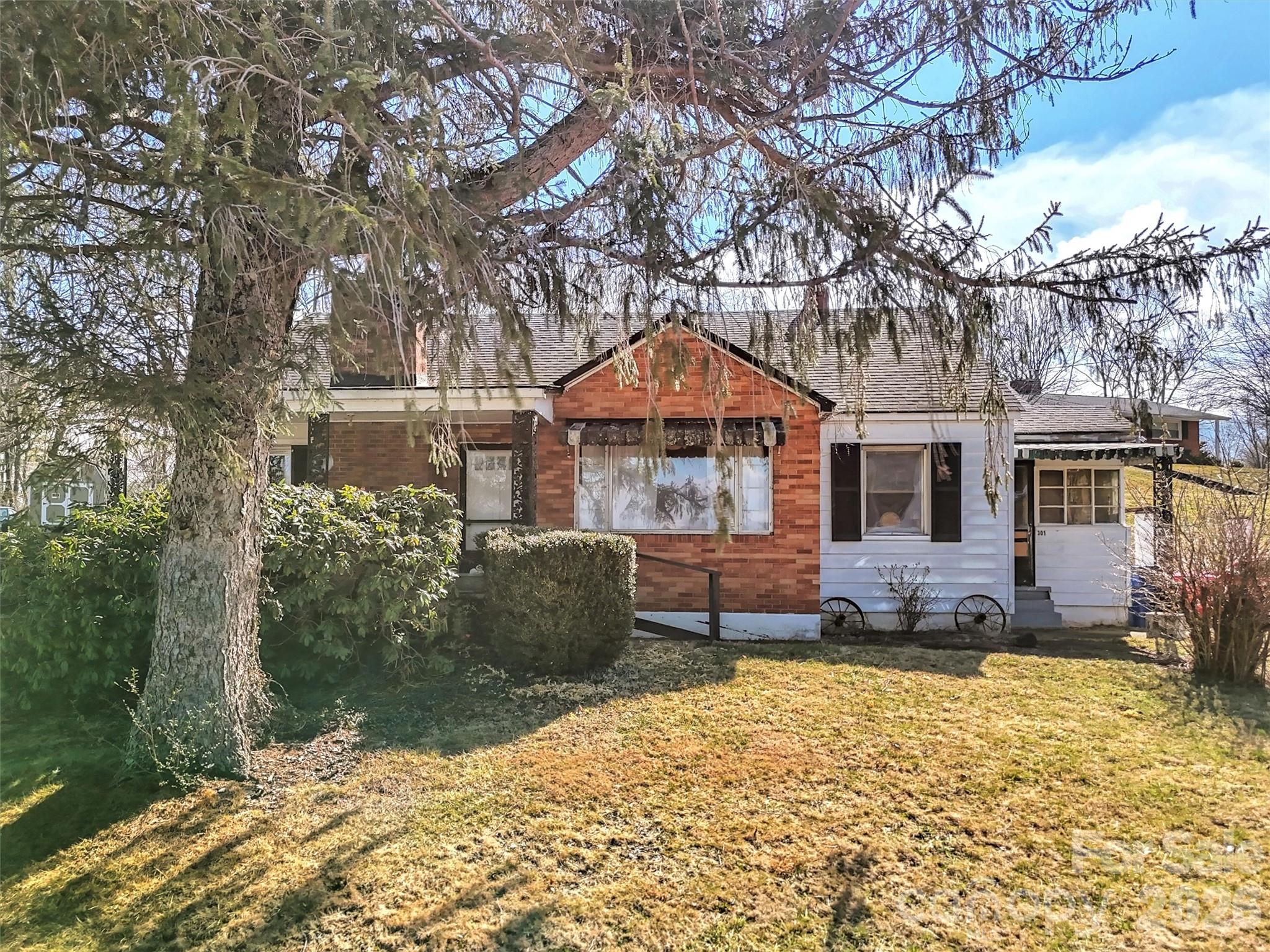 301 Mulberry Street Clyde, NC 28721 - Photo 23 of 23 a front view of a house with a yard covered with snow in front of house