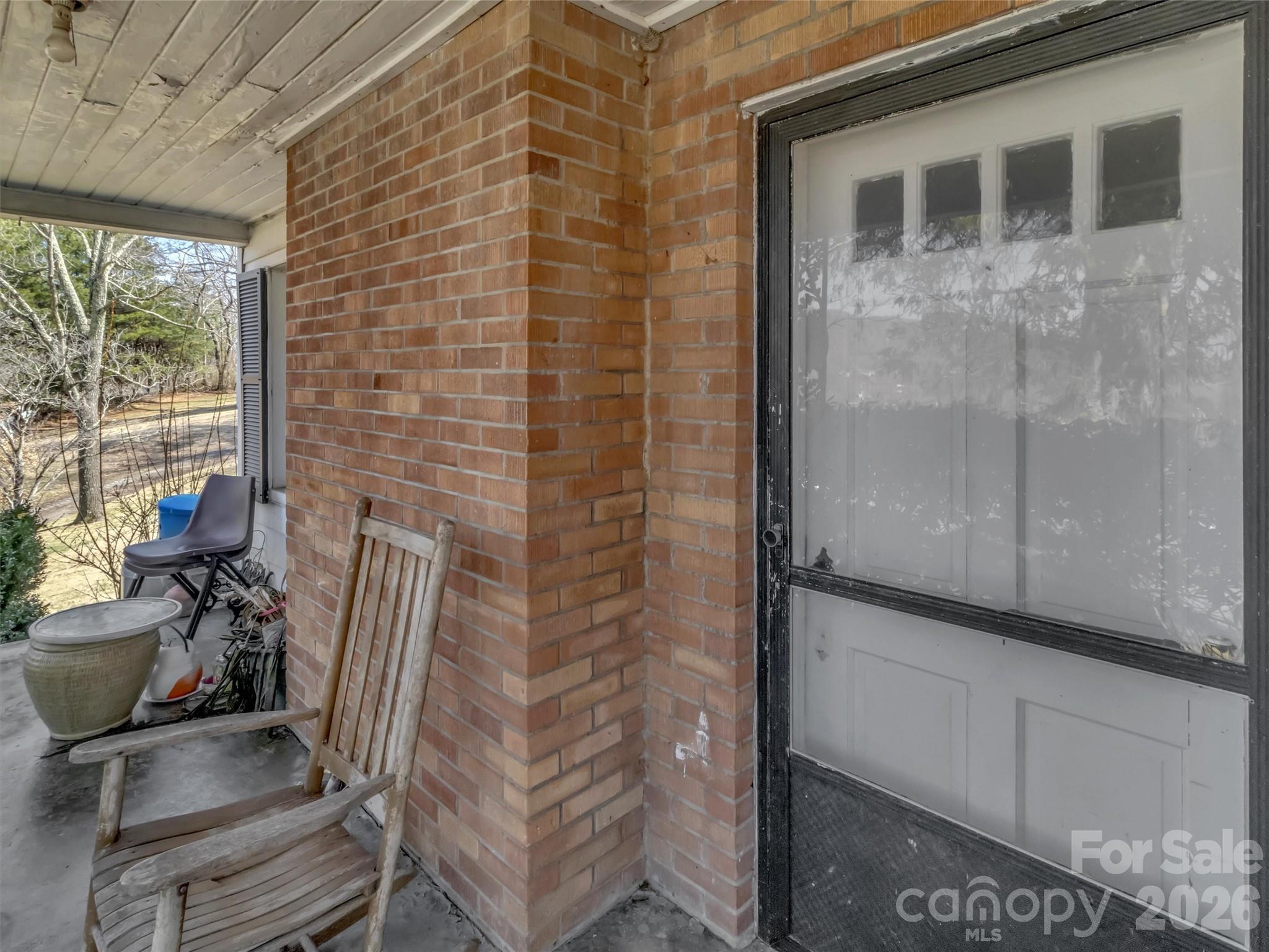 301 Mulberry Street Clyde, NC 28721 - Photo 4 of 23 a view of a door and chair and table in the balcony