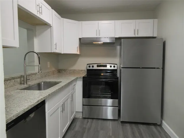 a kitchen with a sink and a refrigerator