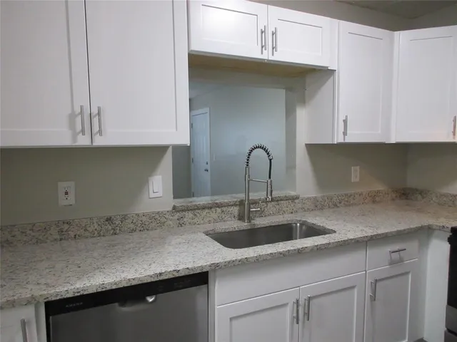 a kitchen with a sink and cabinets