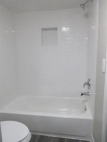 a bathroom with a shower and a toilet