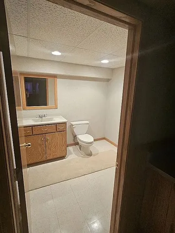 a bathroom with a sink a toilet and mirror