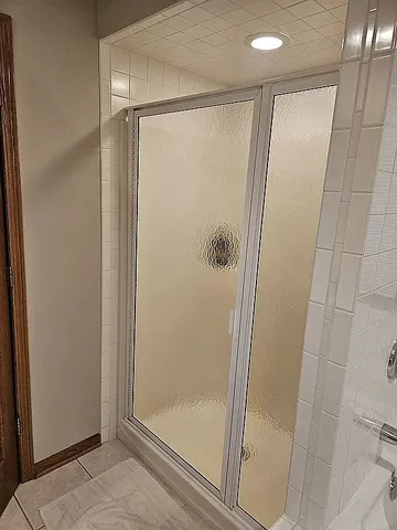 a bathroom with a glass shower door
