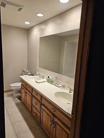 a bathroom with a double vanity sink and a mirror