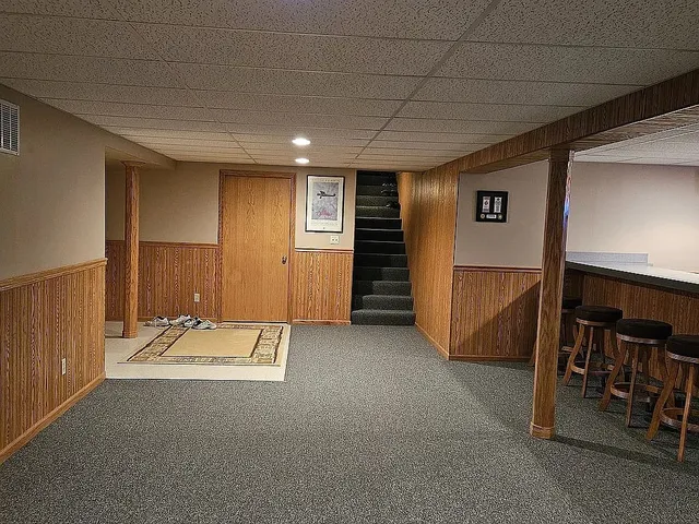 a view of a livingroom with furniture and staircase