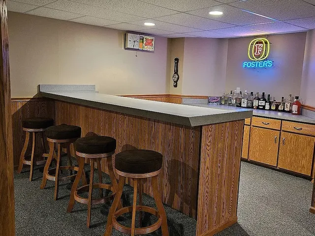 a kitchen with a sink and chairs
