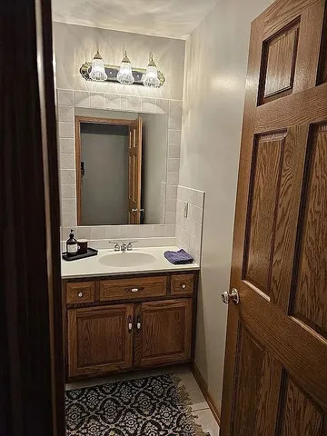 a bathroom with a sink and a mirror