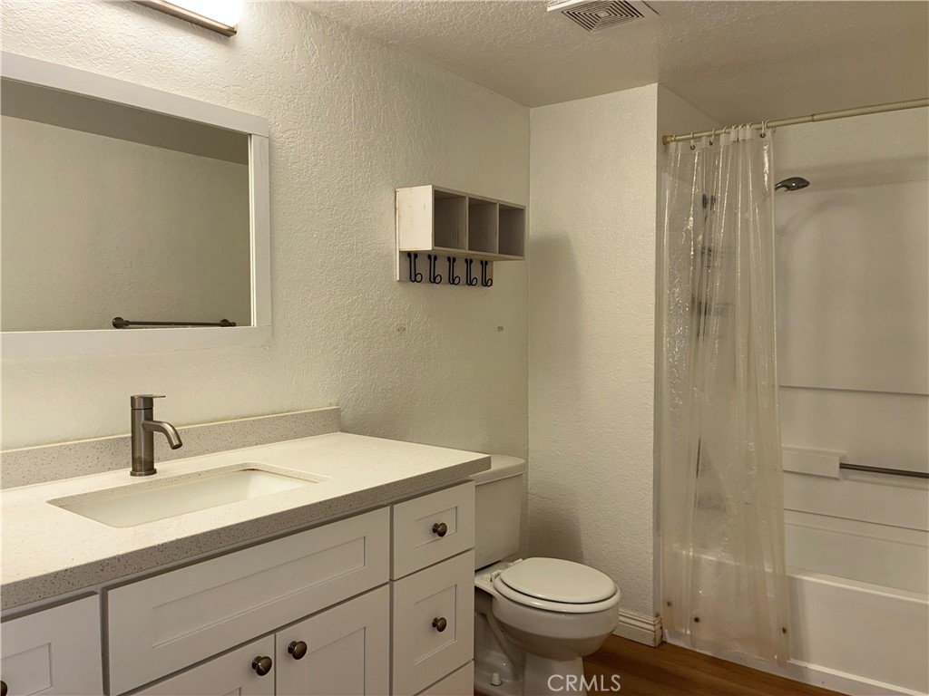 10151 Arrow Route, Unit 11 Rancho Cucamonga, CA 91730 - Photo 14 of 28 a bathroom with a sink a toilet and shower